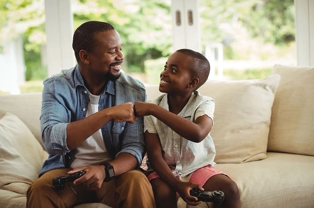 A veteran plays video games with his son
