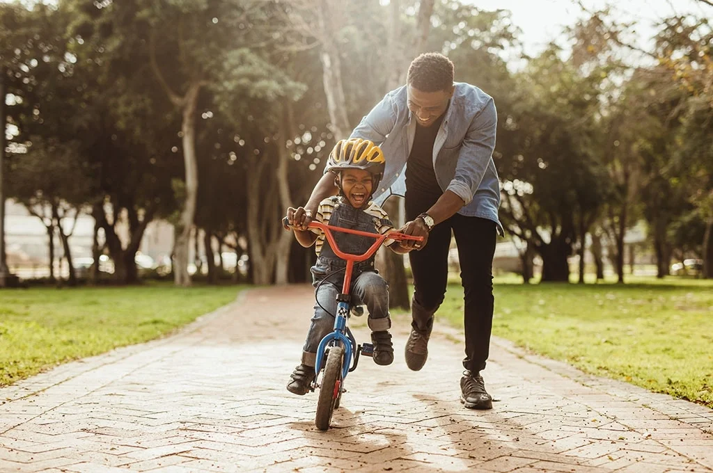 A Floridian veteran father teaching his son how to ride a bike