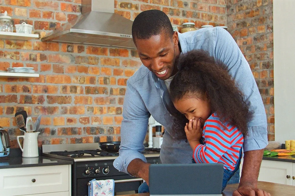 A man at home with his daughter
