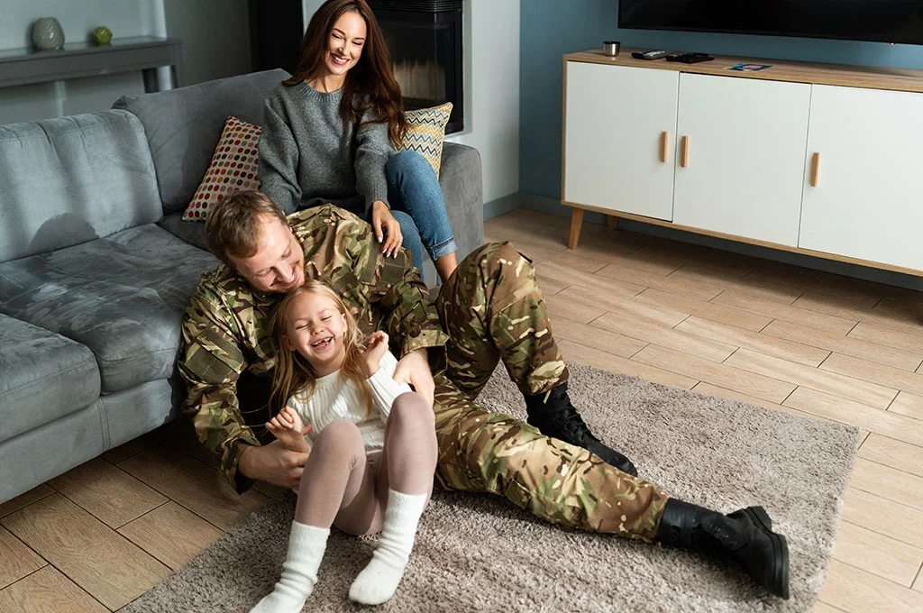 A veteran hanging out with his family in their living room