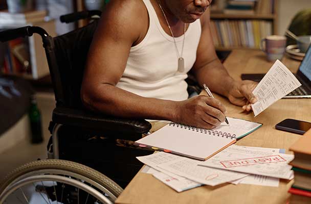 Veteran sitting at his desk managing debt