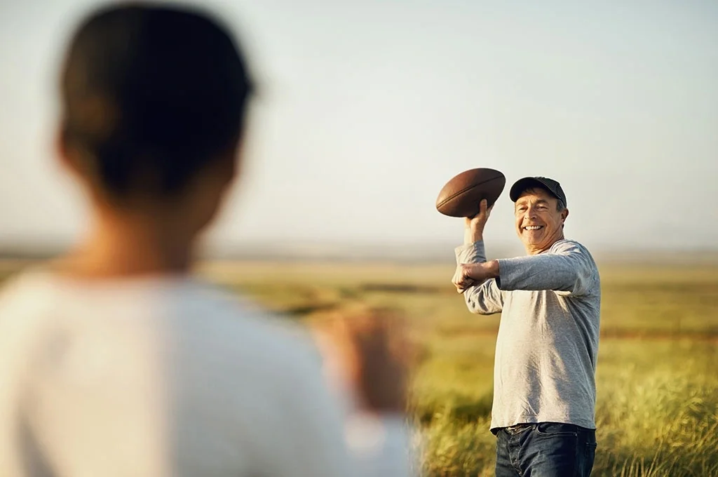 Veteran and his son playing football