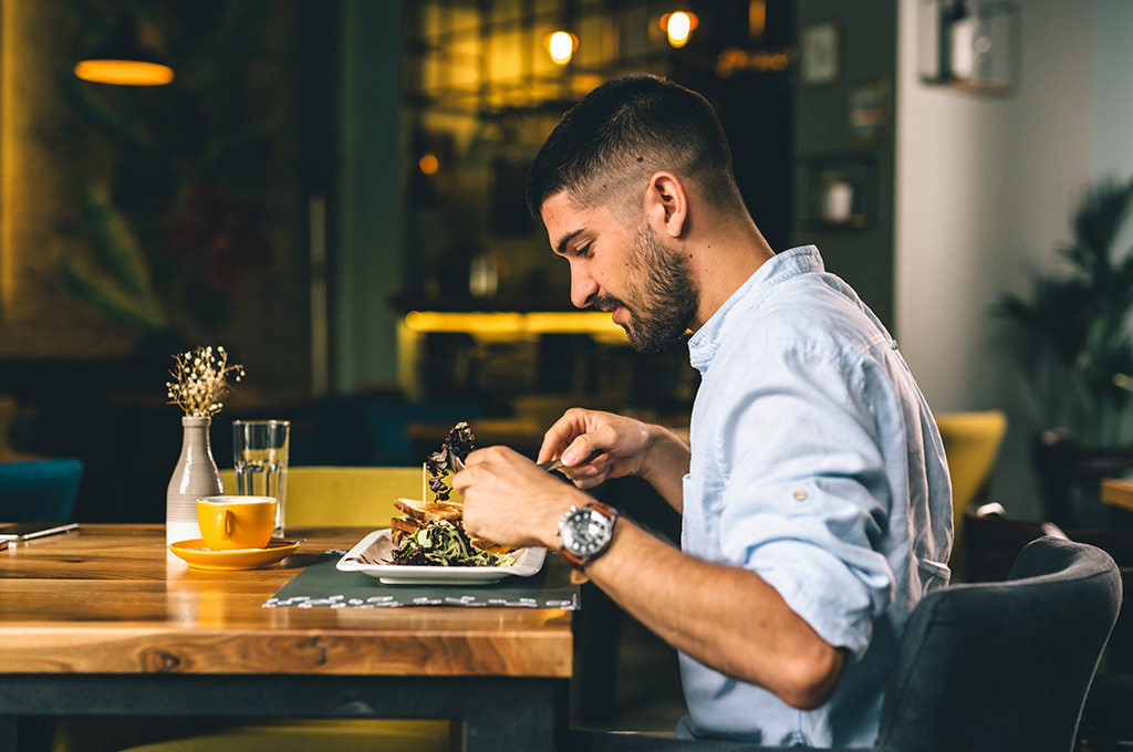 A veteran enjoys a meal he purchased with his military discount