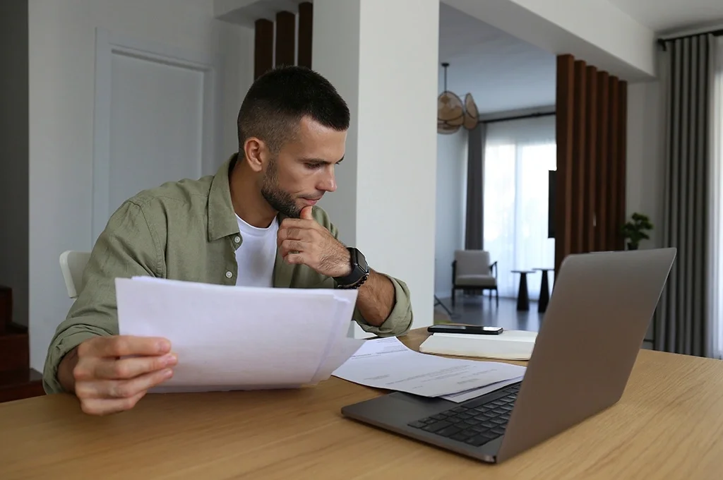 A veteran at home looking over his finances while building better habits