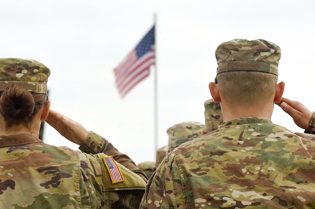 US Army troops saluting the American flag