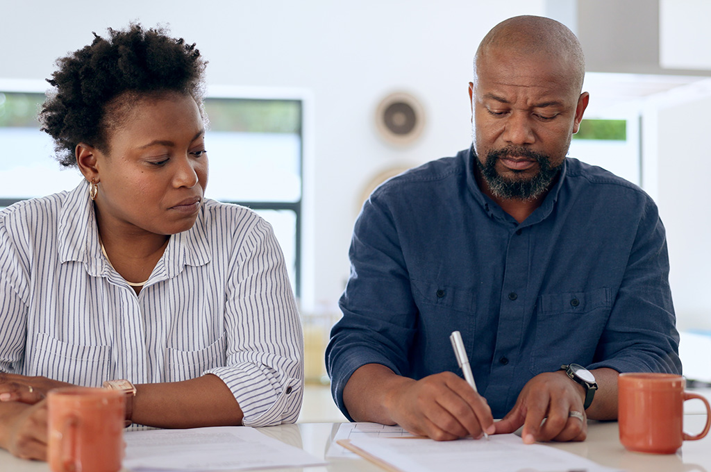 A formerly married couple going over divorce documents.