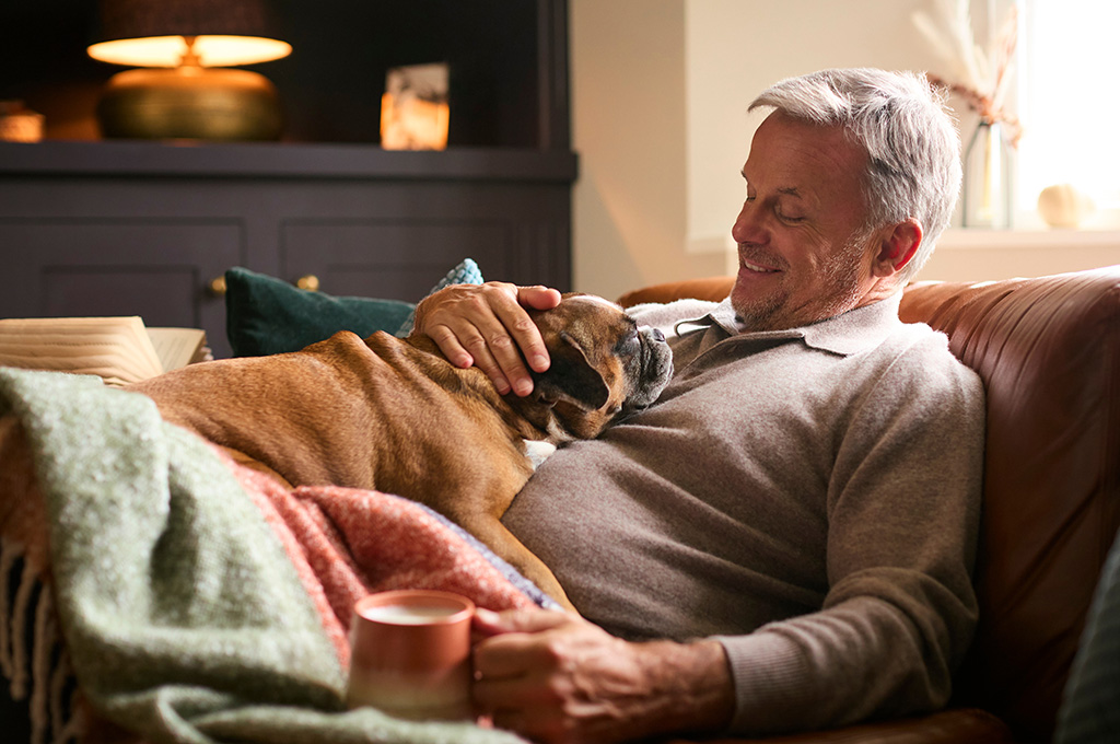 A surviving spouse at home with is dog