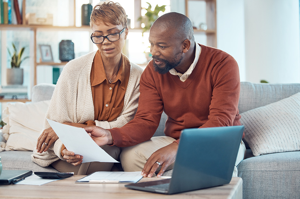 A veteran and his spouse examining the best CD rates for veterans
