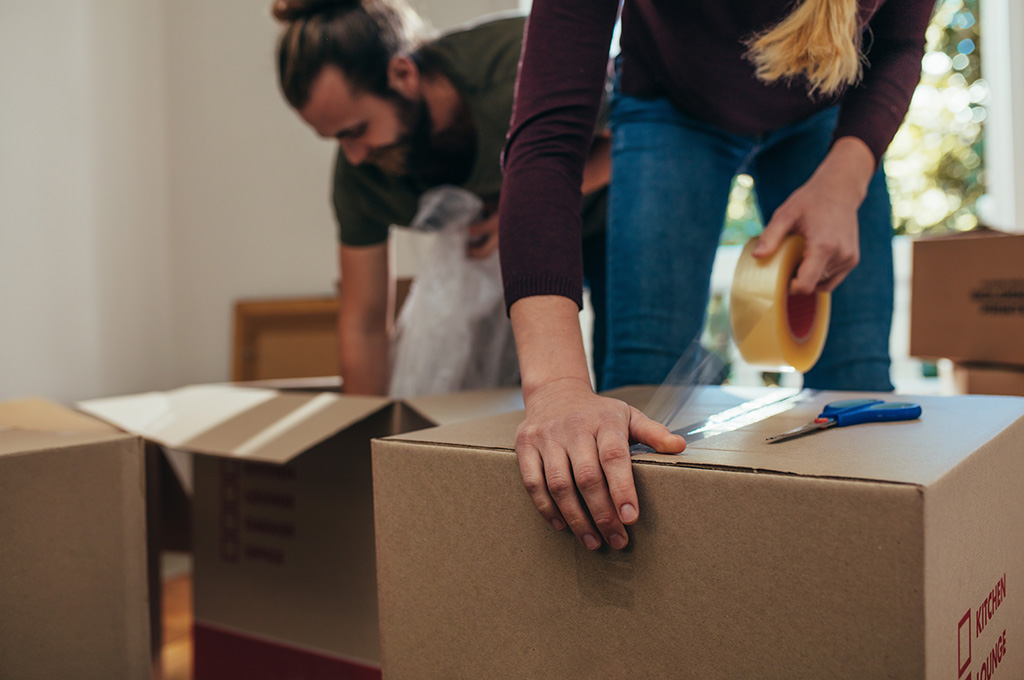 A veteran couple pack boxes to move to one of the best states for veterans to live